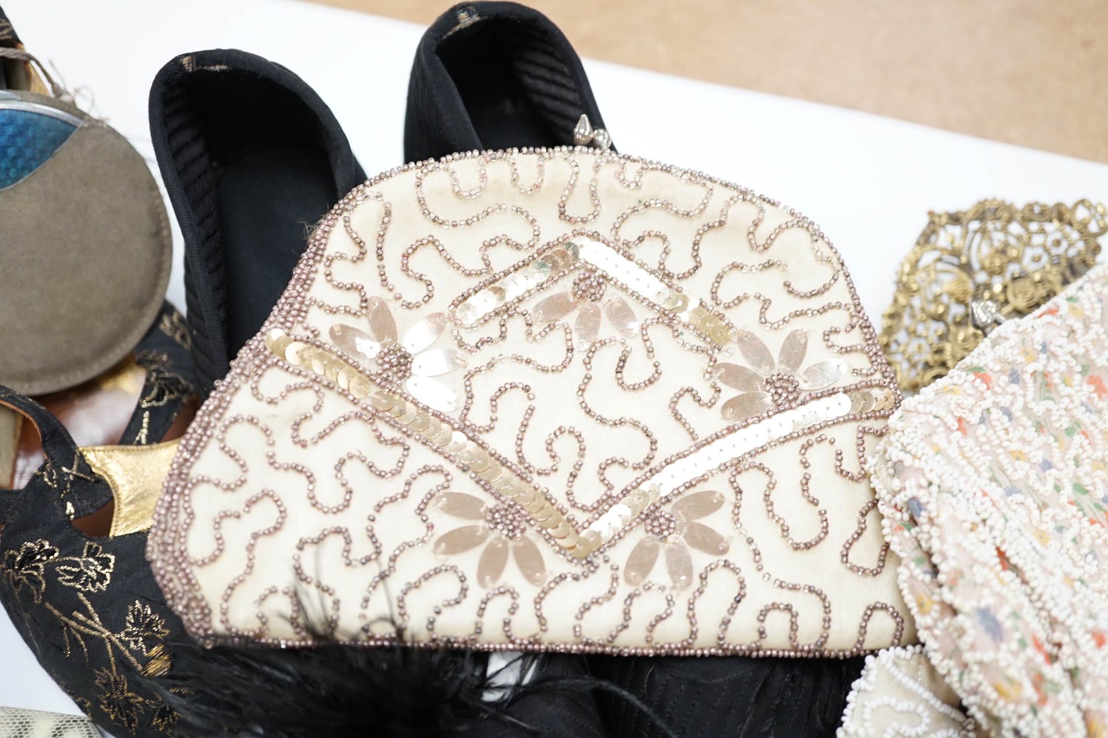 A pair of ladies black feather decorated 1940’s evening shoes, a similar gold leather and brocade pair of shoes, with a collection of bead bags, compacts, etc.